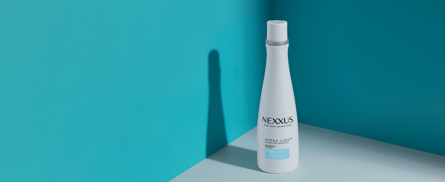 Nexxus Hydra-Light shampoo bottle in a blue corner.