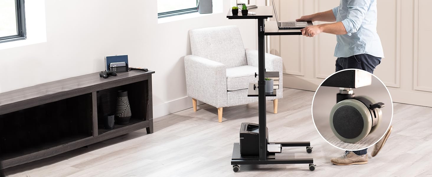 Man pusting mobile workstation across floor