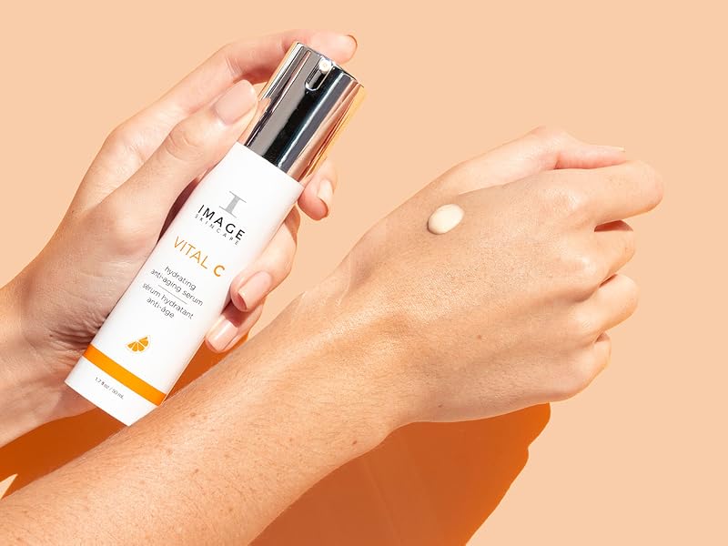 vital c image skincare pumped on a hand with an orange background