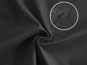 Close-up of dark fabric material with visible water droplets, suggesting water-resistant or waterproof properties.