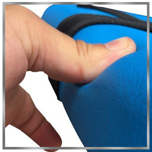 close up on thumb pressing into soft padding on seat. The thumb dents into the plush waterproof foam