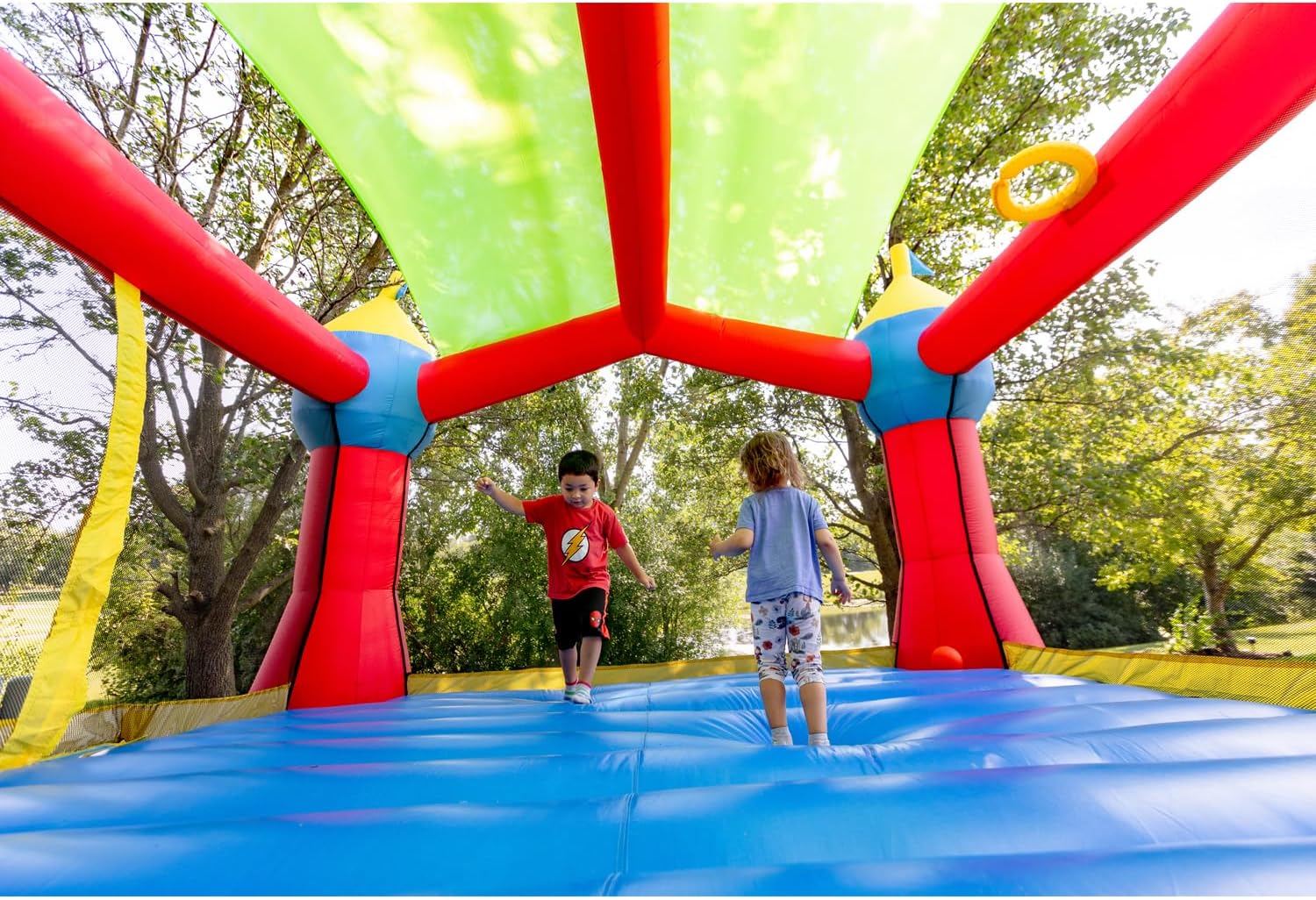 Bounceland Inflatable Party Castle Bounce House Bouncer, 16 ft L x 13 ft W x 10.3 ft H, Basketball Hoop, Removable Sun Roof, UL Strong Blower included