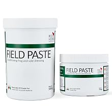 Text reads 'FIELD PASTE'. Multiple white containers with green labels showing the Field Paste product from different angles.