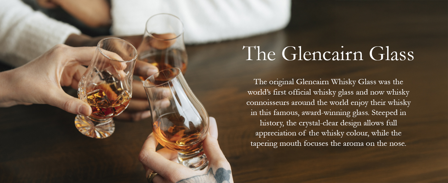 Two hands holding whisky glasses with amber liquid, clinking in a toast. Text describes 'The Glencairn Glass' as a specialized whisky tasting glass.