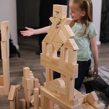 Toddler requeting a block from off camera