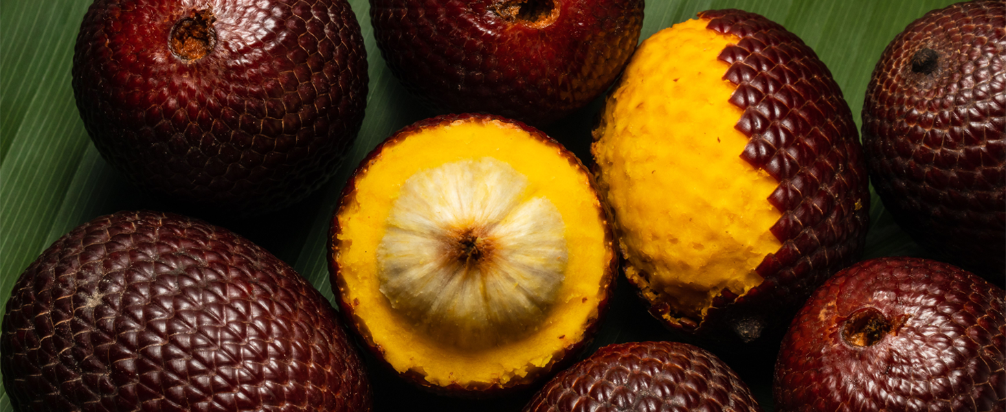 Buriti fruits laid on banana leaves