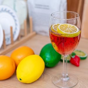a glass of wine with lemons and a lemon.