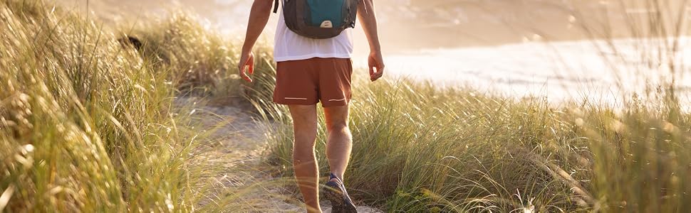 a man walks along the beach