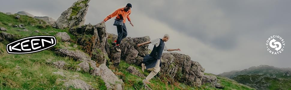 two people hike down a rocky path wearing keen hiking boots.