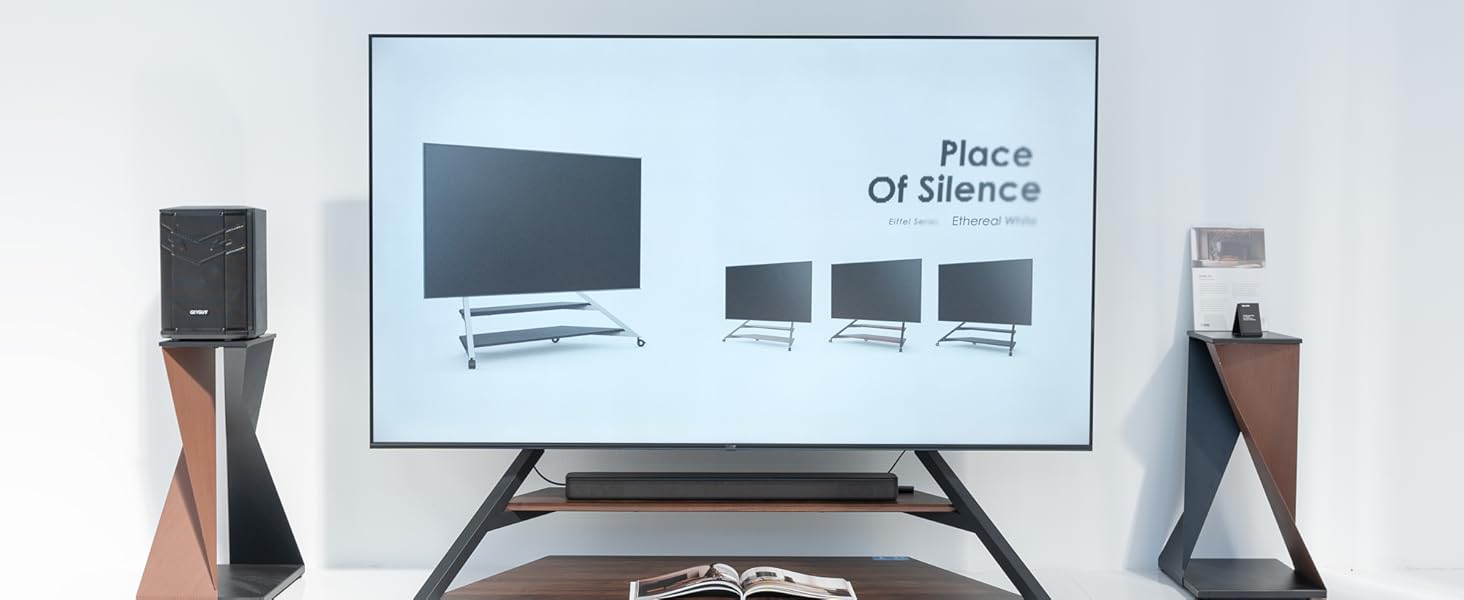 a living room with a television and speakers.