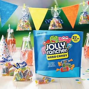 A resealable bag of Jolly Rancher hard candy next to Jolly Rancher goodie bags at a birthday party
