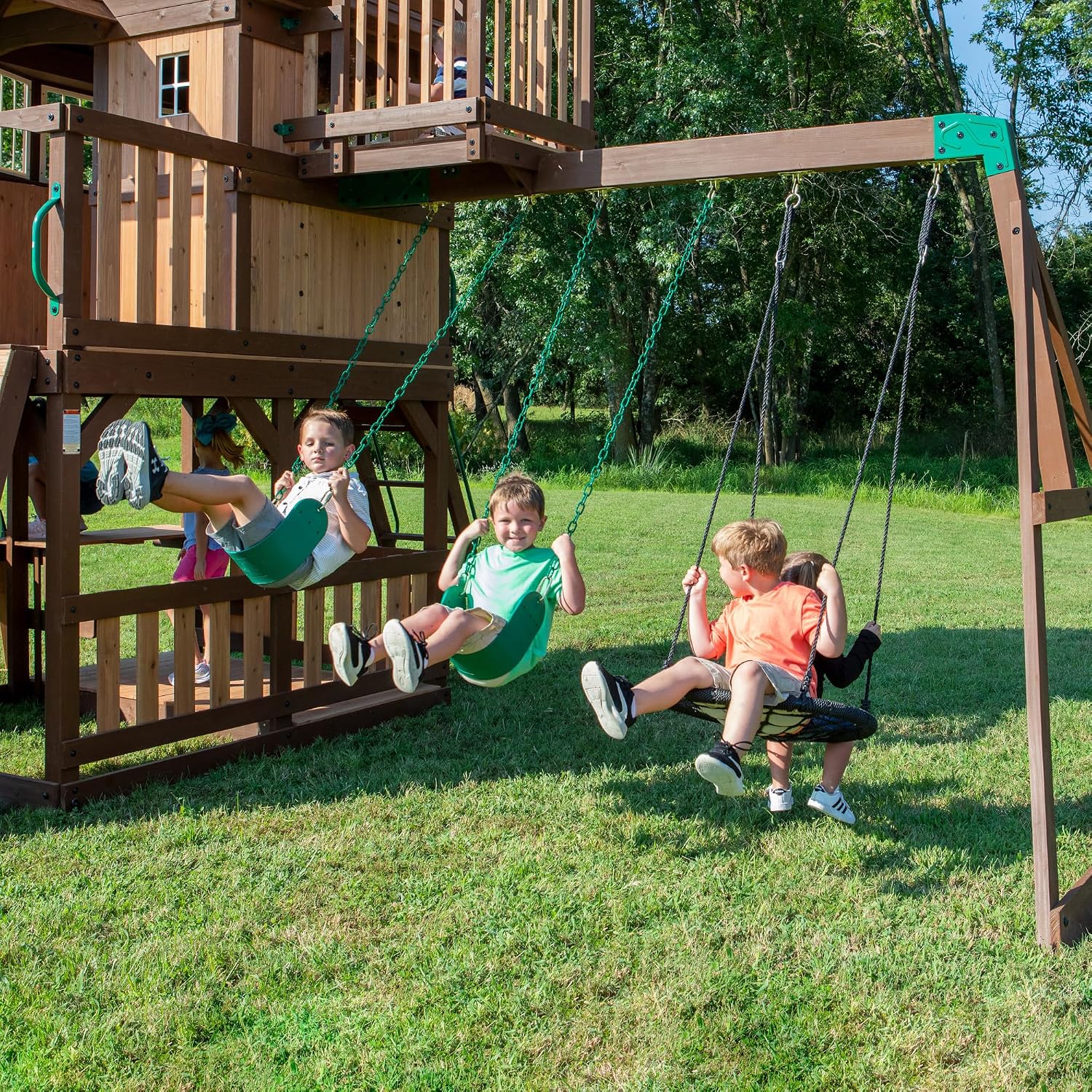 Backyard Discovery Skyfort All Cedar Swing Set, Elevated Covered Wood Roof Clubhouse with Bay Windows, 2 Belt Swings, Web Swing, 10ft Wave Slide