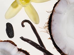 Pieces of coconut with vanilla beans and flowers