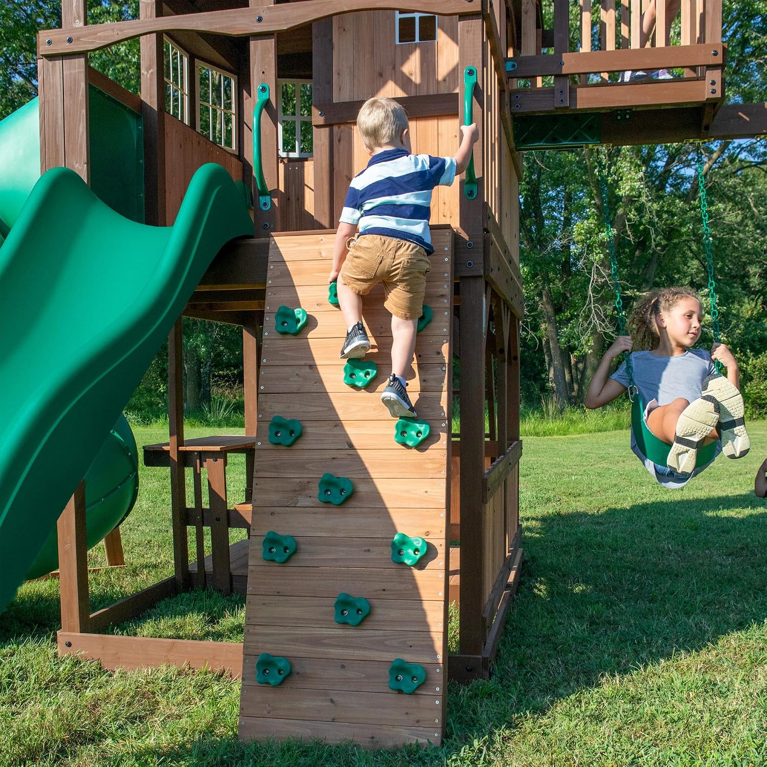 Backyard Discovery Skyfort All Cedar Swing Set, Elevated Covered Wood Roof Clubhouse with Bay Windows, 2 Belt Swings, Web Swing, 10ft Wave Slide
