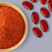 Bowl of paprika sitting next to softgels