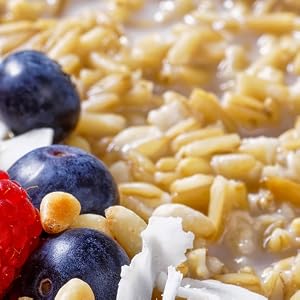 whole oat groats in bowl with berries and milk