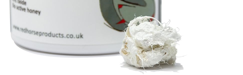 White cylindrical product container with text label, shown from multiple angles with some white substance visible beside it.
