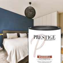 Can of eggshell paint in front of a picture of a bedroom
