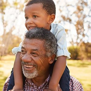 Grandfather carrying grandson on his shoulders