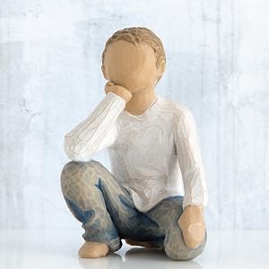 Inquisitive Child figure, forward detail shot of boy sitting knelt down with elbow resting on knee