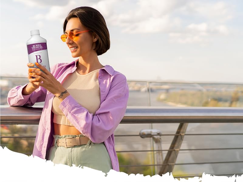 Woman holding bottle of B Complete