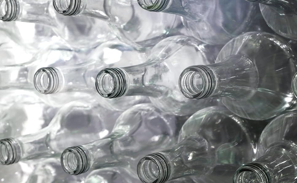 Clear glass bottles stacked laying horizontally.