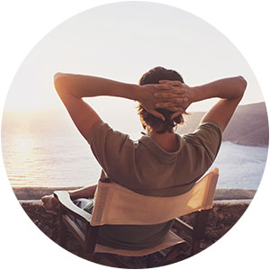man sitting looking comfortable looking out at the ocean
