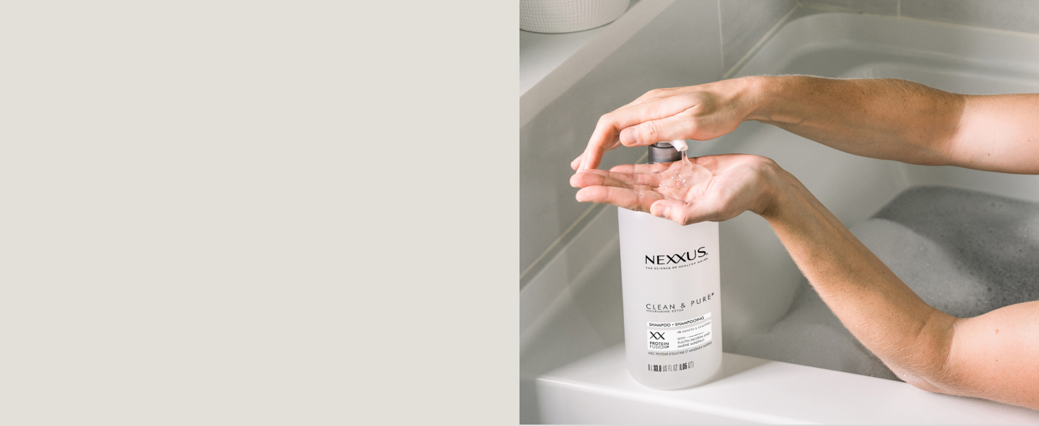 Nexxus Clean &amp; Pure shampoo bottle being pressed from its pump, pouring shampoo to another hand.