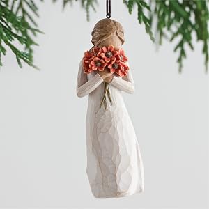Willow Tree Surrounded by Love ornament holding large bouquet of red-orange poppies up to face.