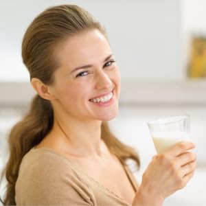 Woman smiling drinking goat milk easy to digest A2 milk protein