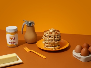 NAKED Organic Peanut Butter drizzle over pancakes