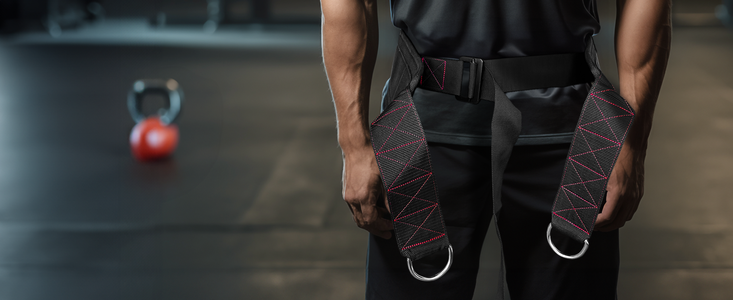 Close-up of athlete wearing sled pulling belt with reinforced D-rings and adjustable waist strap