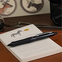 Photo shows Dr. Grip Full Black pen resting on a pad of paper