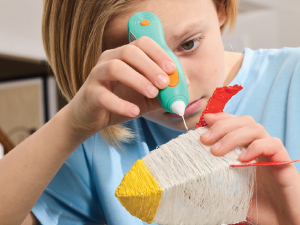 Boy designing rocket with 3Doodler 3D printing pen.