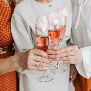 Pink wine in glasses toasting at wedding