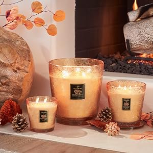 Spiced Pumpkin Latte Hearth Candles in various sizes in front of a fireplace.