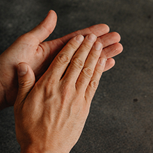 Hands rubbing Clay Pomade together