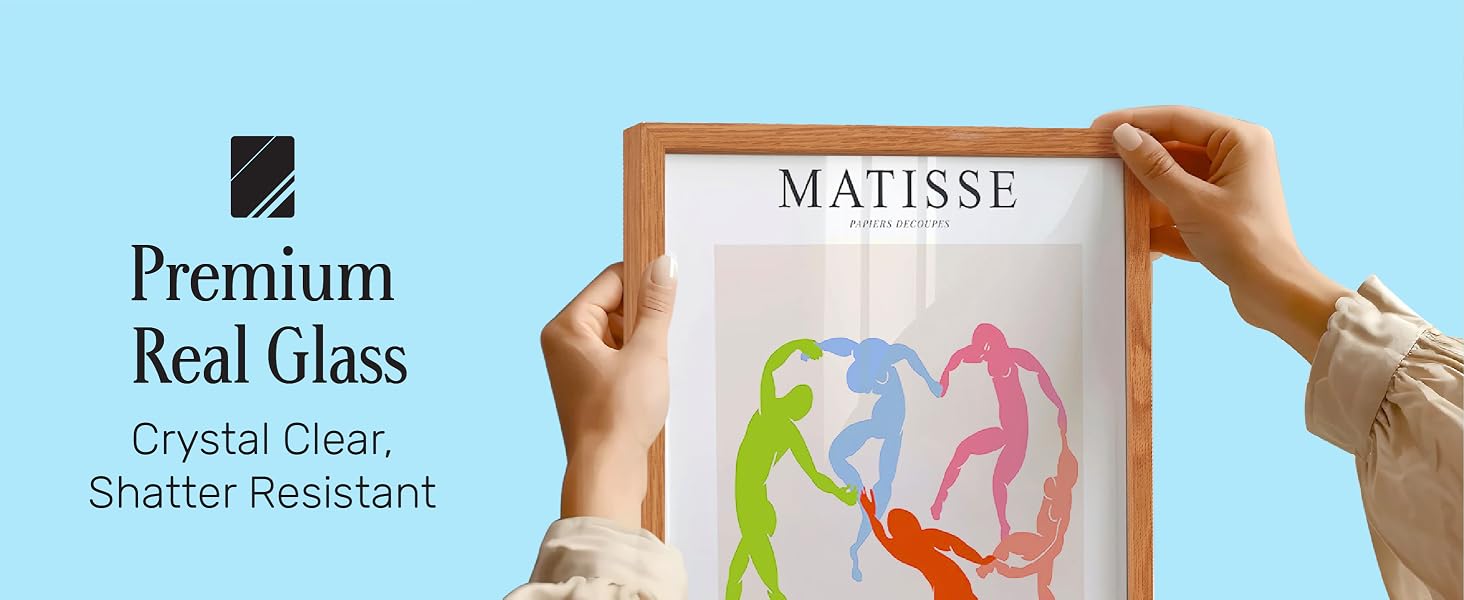 Hands holding framed Matisse print with clear, shatter-resistant glass