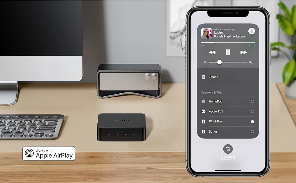a phone and a speaker on a desk.