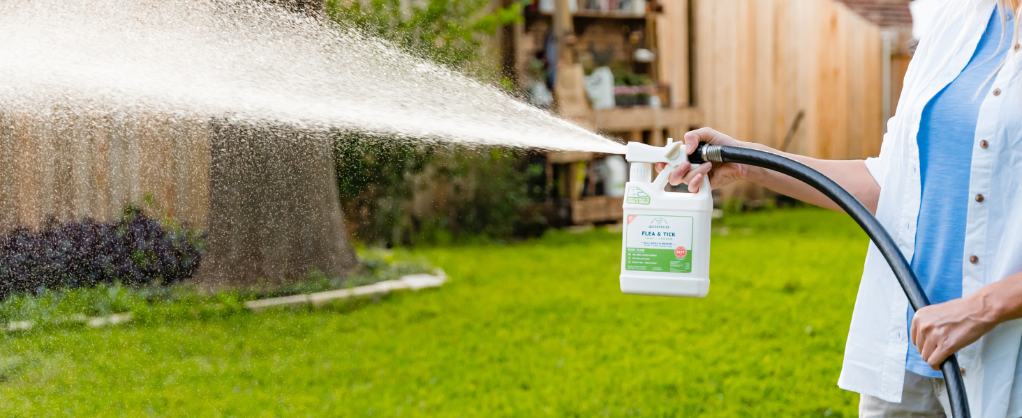 A person spraying Wondercide in their yard