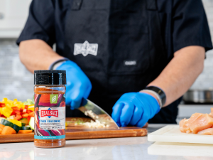 Image of Redmond Real Salt spilling onto a wooden cutting board.