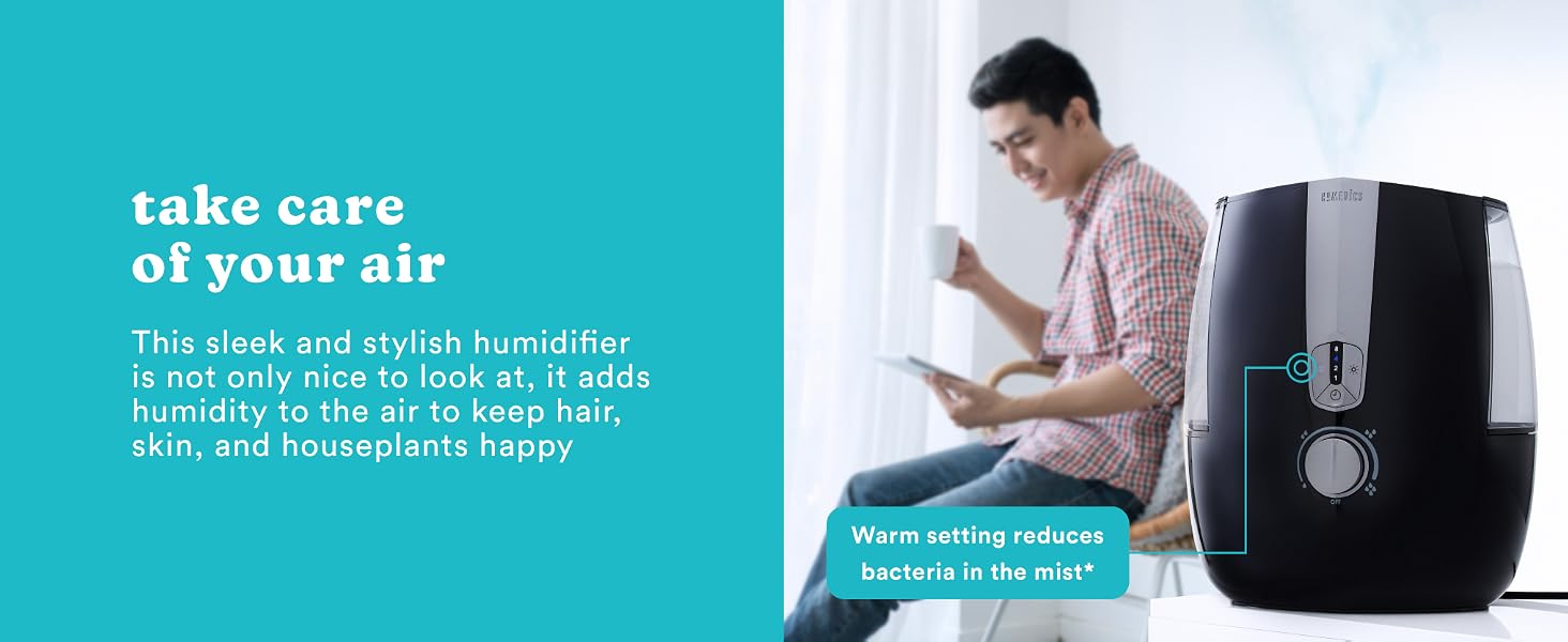 man sitting next to black humidifier in bedroom