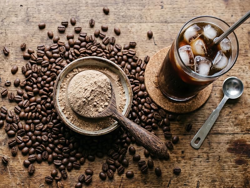 rustic table featuring scoop of whey isolate protein powder with iced coffee cold brew