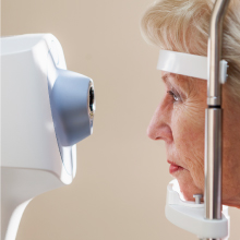 Woman in front of eye testing machine