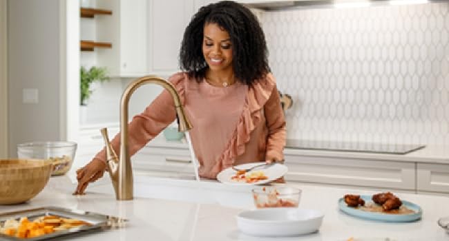 Woman by sink using garbage disposer