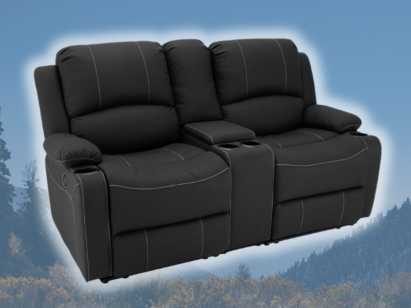 Black double recliner with white stitching. Background is mountains.