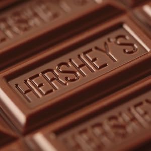 Close up image of an unwrapped Hershey's milk chocolate bar