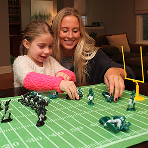 kid playing a pretending to tackle opponents team on the field