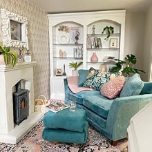 a living room with a blue sofa and a wood burning stove
