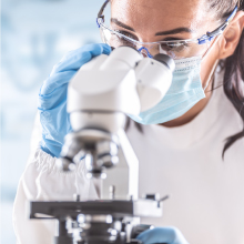 Woman looking into microscope
